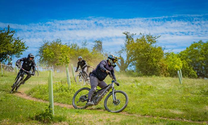 A group of riders enjoying dusty trail conditions.